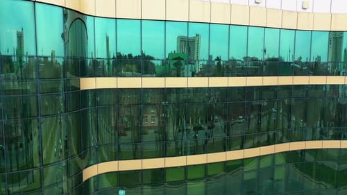 Facade of modern glass building. Surface of glass building with the city reflection