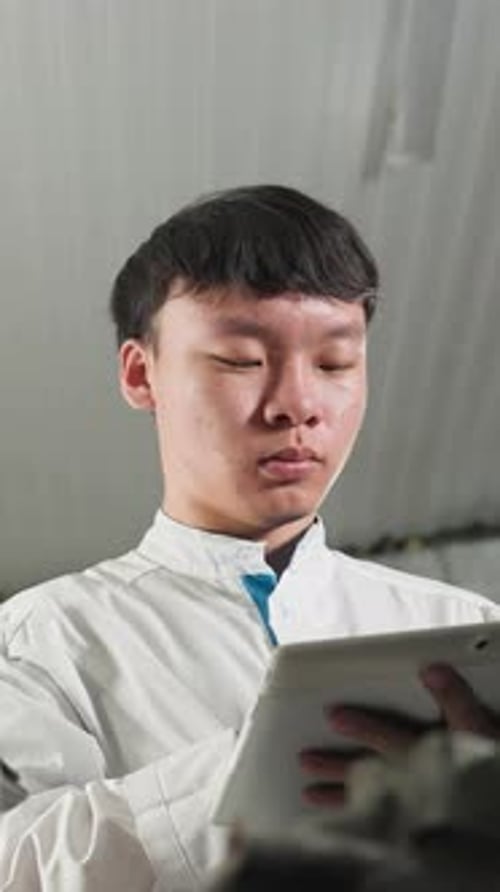 Technicians Take Notes on Tablets in Automotive Workshop