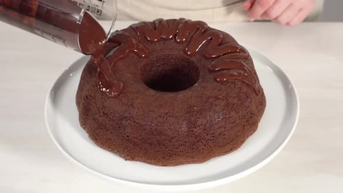 Step By Step Freshly Baked Chocolate Bundt Cake on a White Cake Stand