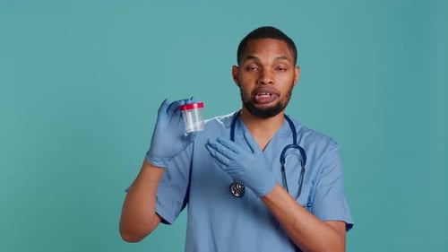 Portrait of Nurse Holding Blood Sample Container Doing Medical Investigation