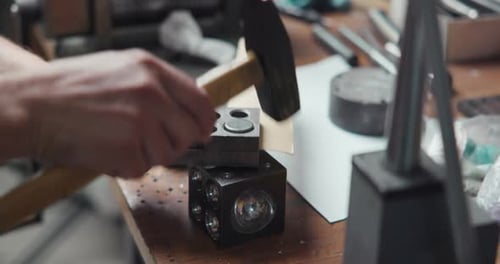 Jeweler Presses Out a Cardboard Blank Using Molds and a Hammer Making Polish Disk for Jewelry Ring