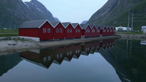 Calm Reflections: Red Houses by Norwegian Fjord