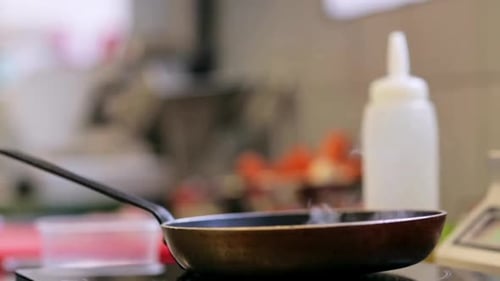 Frying Pan Steaming on Stove in Kitchen