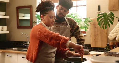 Couple Cooking Together in Kitchen with Warm Sunlight