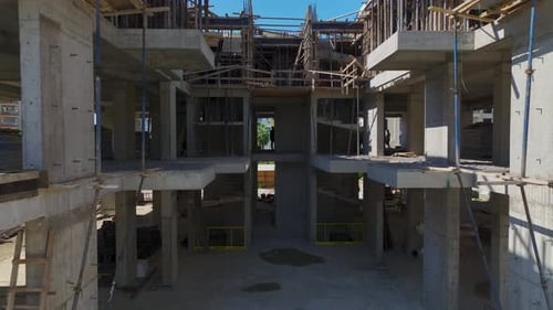 Vista aérea de un bullicioso sitio de construcción con trabajadores que utilizan su experiencia para progresar