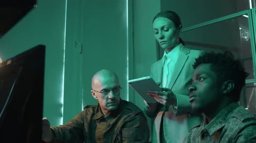 Team Working in Dark High Tech Control Room