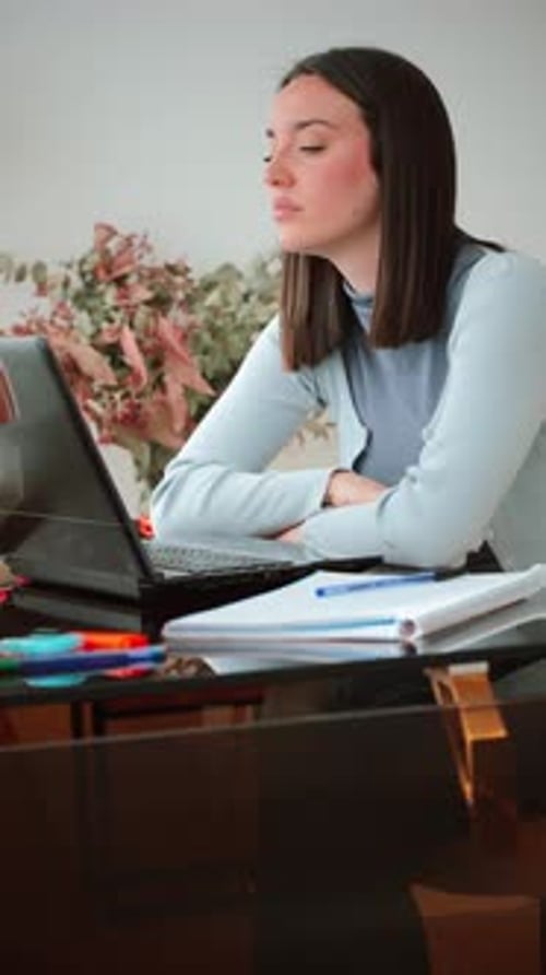 Frustrated Young Woman Experiencing Stress While Working on a Laptop During a Busy Study Session