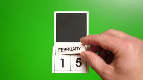 Hand Adjusting a Calendar to February 15th