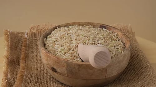 Wooden Bowl of Brown Rice with Scoop