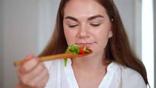 Woman Eating Healthy Salad in Close Up