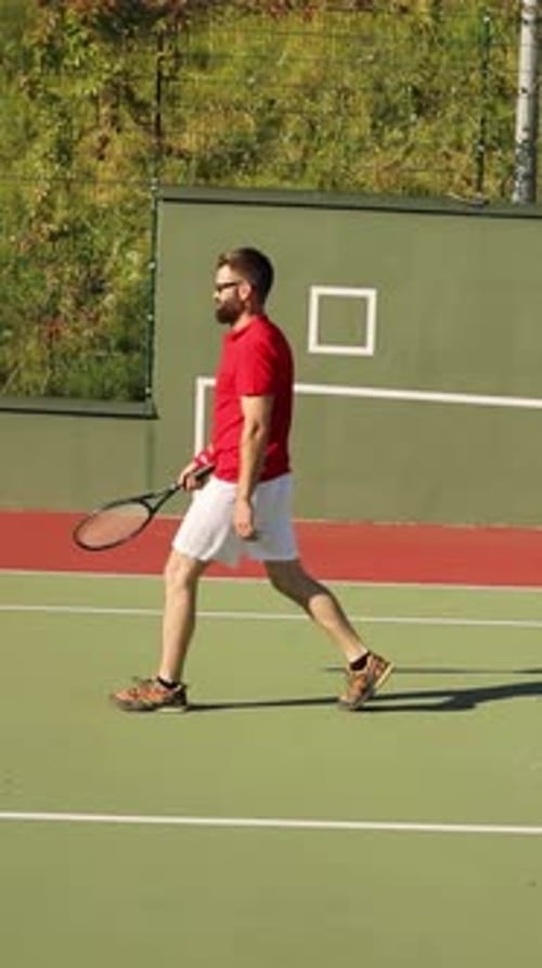 An Enthusiastic Man Plays Tennis on a Vibrant Court Under Bright Sunlight Showcasing Skill