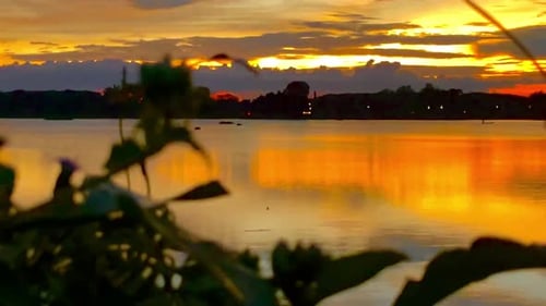 The beautiful sunset over the calm waters of the lake makes for a perfect view