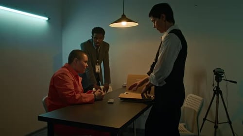 Person Interrogated by Police in a Dim Room