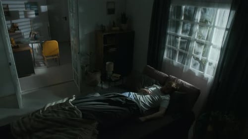 Adult Wakes Up in Cozy Bedroom at Night