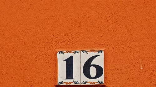 Number 16 (sixteen) Affixed to a Building