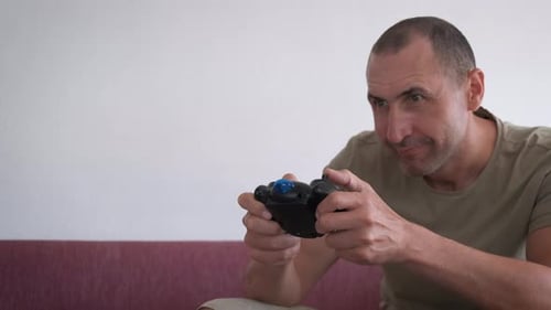 Man Plays Video Game on Couch