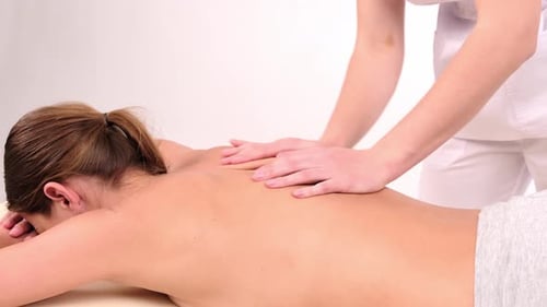 Woman Receiving Relaxing Back Massage at a Spa