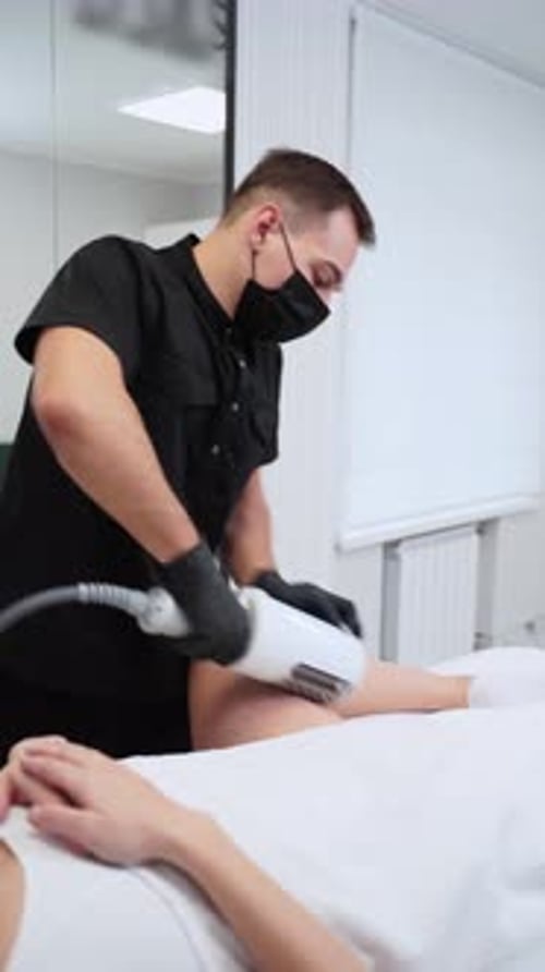 Medical Professional Treating Patient with Skincare Device