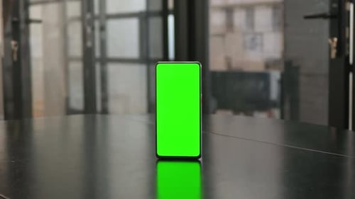 Smartphone with Green Chroma Key Screen on Desk