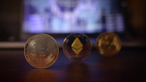 A Variety of Cryptocurrency Coins Are Displayed in Front of Relevant Market Data and Trends