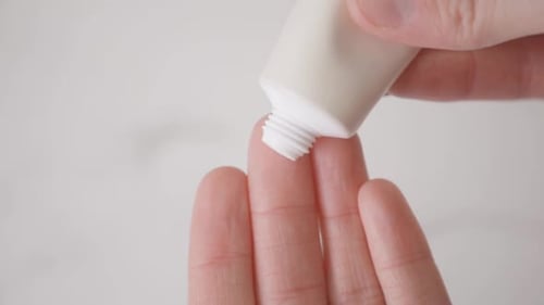 Cream Being Applied onto a Finger