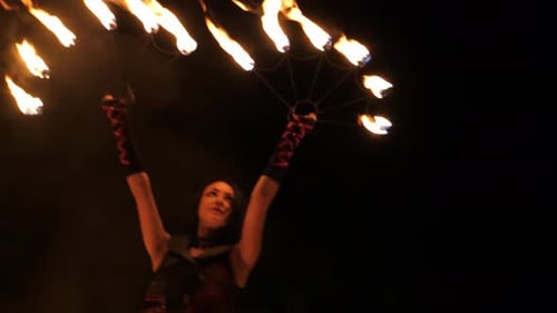 Woman Performs Fire Dance at Night