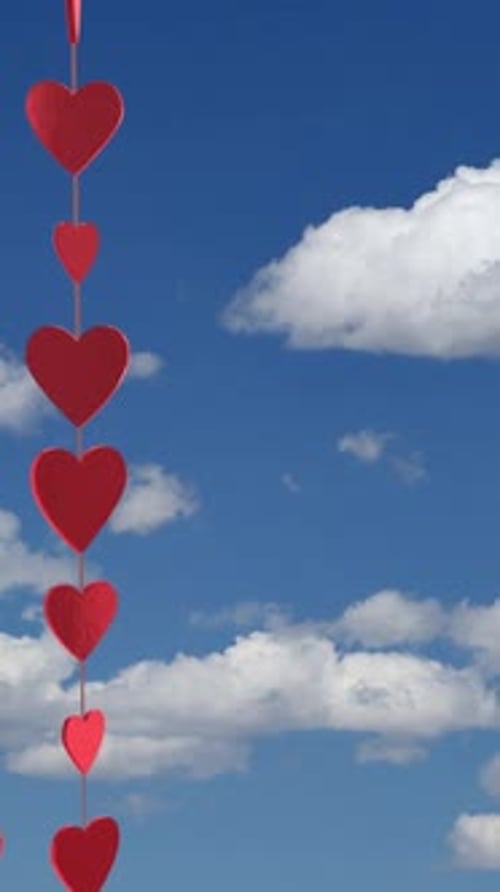 Valentines Day String of Hearts with Blue Sky Background Vertical