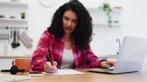 Woman Working from Home at Kitchen Table