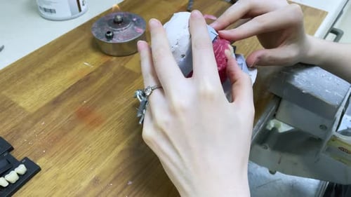 Dental Professional Crafting Teeth With Precision Tools