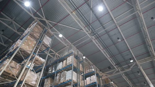 Camera glides through orderly goods and materials in modern logistics warehouse
