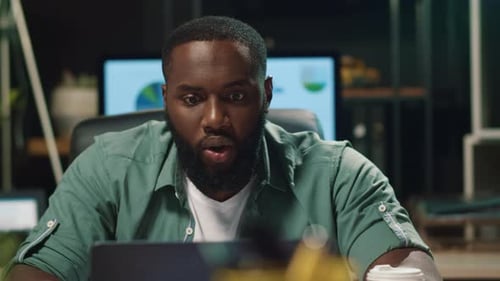 Man Reacts with Disgust, then Smiles at Laptop