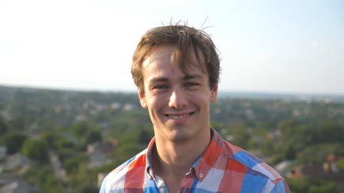 Smiling Young Man Close-up Portrait With City Background
