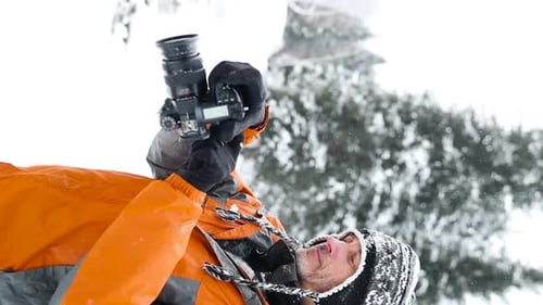 Man with Camera in Snowy Winter Landscape