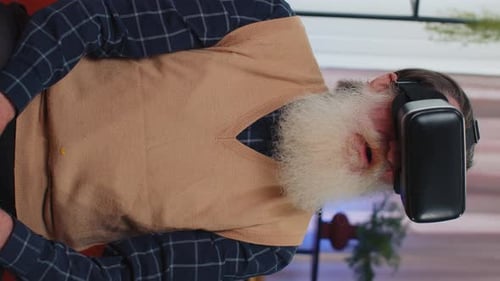 Senior Man Uses VR Headset Indoors