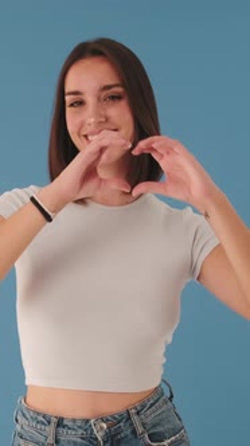 Smiling Woman Making Heart Symbol With Hands