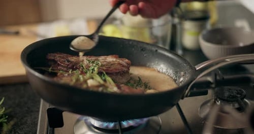 Sauce Poured Over Meat Cooking in Pan