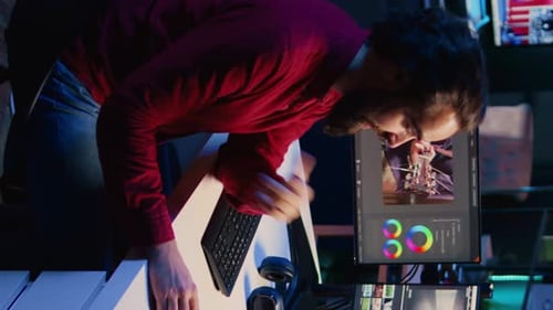Man edits video at his workstation