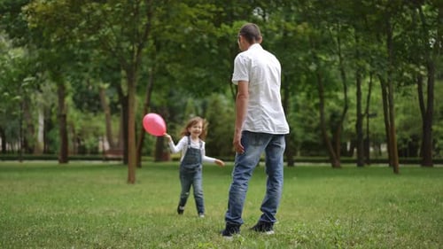 Father and His Child Are Enjoying Playtime Together in a Beautiful Park