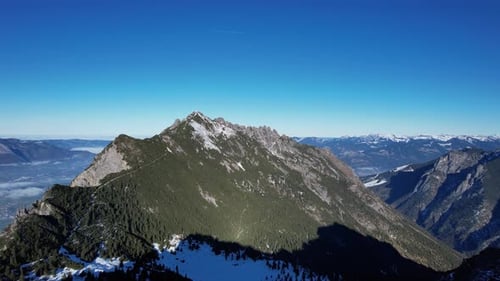 Aerial shot flying directly to the mountain Kuhrgrat in Liechtenstein next to switzerland during a s