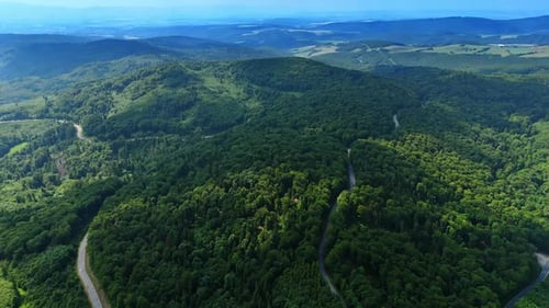 Expansive aerial view of forested mountain ranges.