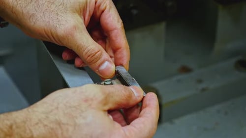 Close Up of Worker Hands Putting Small Metal Tile for Processing in Industrial Machine Stock Footage