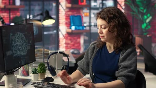 Woman Coding Artificial Intelligence at Computer in Office