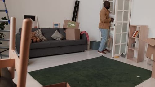 Couple Carrying Furniture Into New Home
