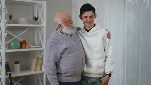 A Joyful Intergenerational Moment Shared Between Two Men in a Lively Setting Outdoors