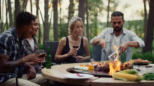 Cheerful People Having Rest on Grill Party on Backyard. Relaxed Fellows Cooking