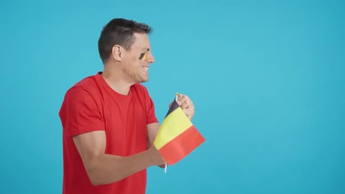 Nervous Man Cheering for Belgium During a Match Looking Away