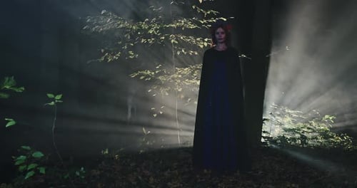 Woman in Forest at Halloween Night