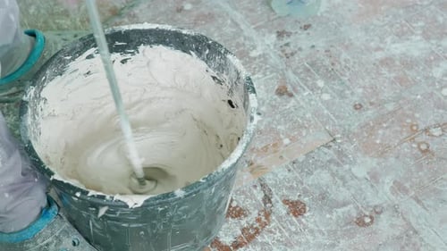 Plaster Being Mixed in Bucket with Drill