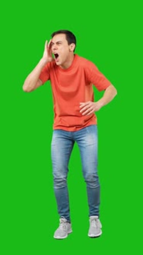 Amazed Man Touching Cheek in Studio Green Background