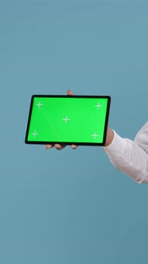 Vertical Video Doorkeeper Bellboy Poses with Green Screen on Tablet at the Hotel Reception